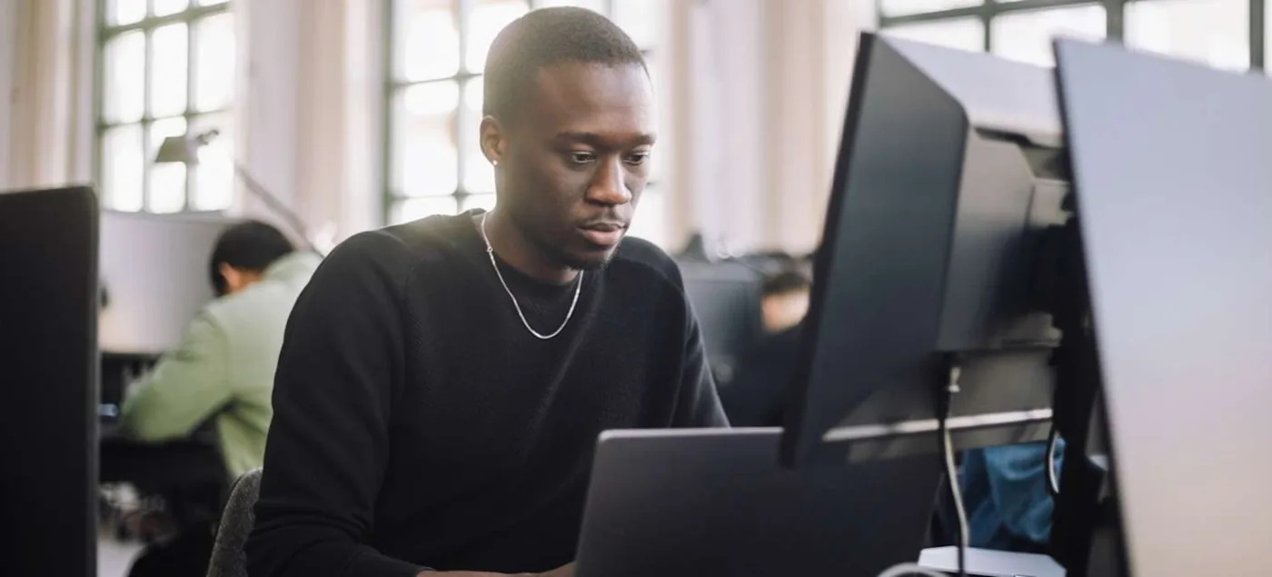 Data analyst reviewing work at a computer